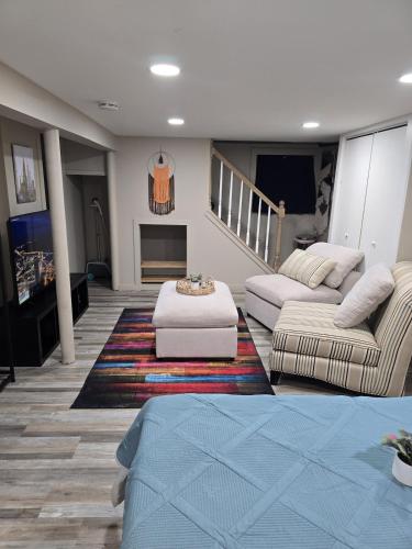 a living room with two couches and a fireplace at The Nook Suite in Hackensack