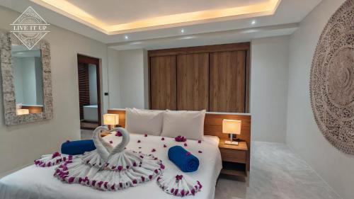 a bedroom with a bed with two swans on it at Santi Tara Villas in Amphoe Koh Samui