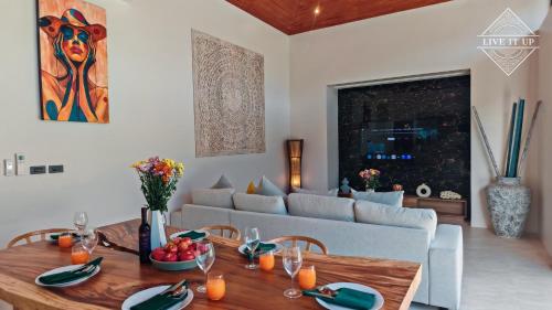 a living room with a table and a couch at Santi Tara Villas in Amphoe Koh Samui