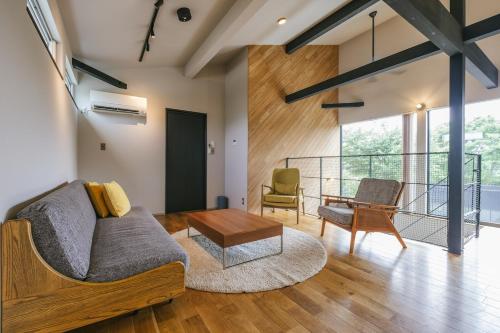 a living room with a couch and a table at 青山 loop in Yamanakako