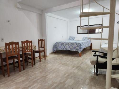 a living room with a bed and a table and chairs at Alter Centric Vila na Trav Copacabana in Alter do Chao
