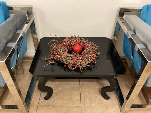 a black table with a red apple on it at Coin Apartments & Poshtel in Chernivtsi