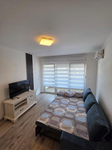 a living room with a couch and a flat screen tv at Stan na dan Brčko Zaga Profesora Esada Pitića 7 in Brčko