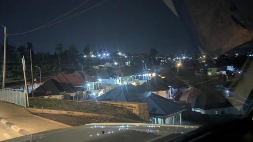 a view of a city at night with lights at UMUBANO RESIDENCE KIGALI Kabeza in Kigali
