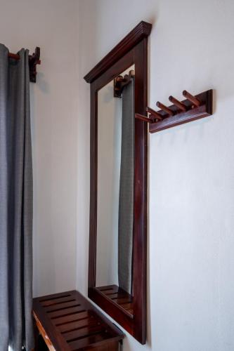 a wooden mirror hanging on a wall in a room at Camino Verde B&B Monteverde Costa Rica in Monteverde Costa Rica