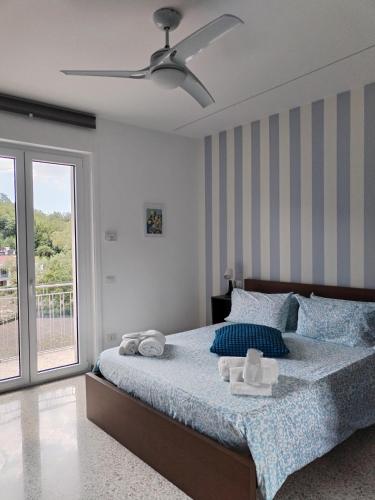 a bedroom with a bed with blue sheets and a window at Da Zi'Anna in Baronissi
