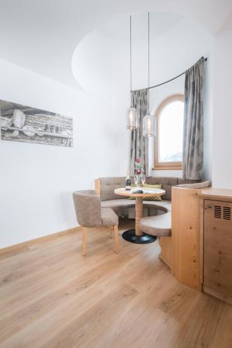 a living room with a table and a couch at Alpenkönig in Zell am Ziller