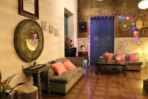 a living room with a couch and a blue door at Hotel Brunette in Santa Ana