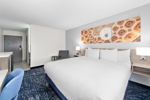 a hotel room with a bed and a desk at Clarion Pointe in Shreveport