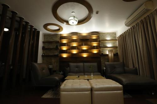 a room with a table and two chairs and a couch at The New Marrion in Bhubaneshwar