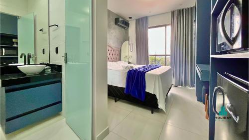 a bathroom with a bed and a sink in a room at Compact Time by Holiday Stays in João Pessoa
