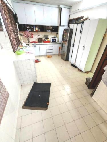 a kitchen with white cabinets and a black rug on the floor at 欢唱名宿 in Kluang