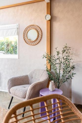 a living room with a chair and a table at Cozy Stay Veluwe met hottub in Putten