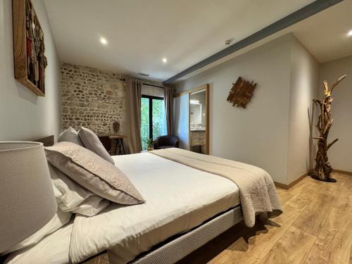a bedroom with a large bed in a room at Hotel Le Galambre in Nîmes