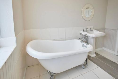 a white bathroom with a tub and a sink at Great Ayton Townhouse Retreat-Sleeps 6-3Bed-2Bath in Great Ayton