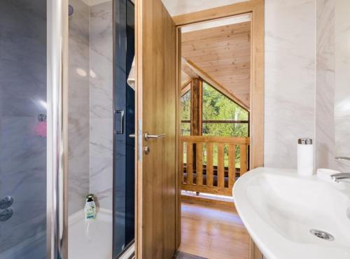 a bathroom with a tub and a sink and a window at Holiday Home Elizabeta in Slunj
