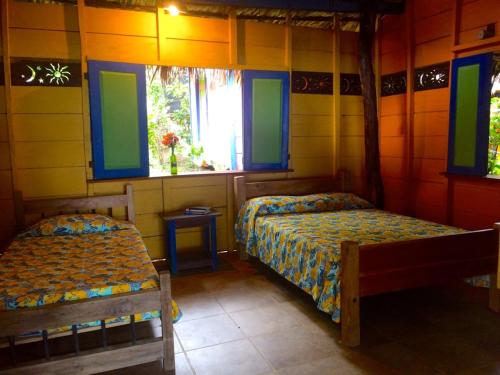 a bedroom with two beds and a window at Reserva Natural Viento Solar in Cedro