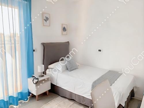 a white bedroom with a bed and a window at Hotel Niagara in Lido di Jesolo