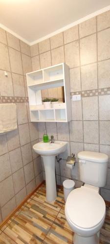 a bathroom with a toilet and a sink at Casa Turismo Freirina in Freirina