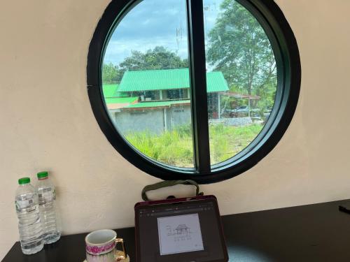 a table with a window and a picture of a building at 359รีสอร์ท in Ban Tha Kasem