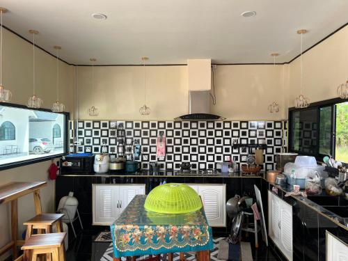 a kitchen with a table with a green bowl on it at 359รีสอร์ท in Ban Tha Kasem