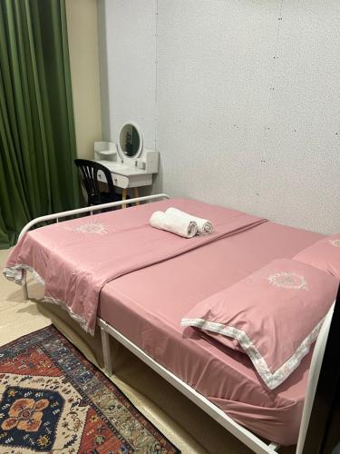 a hospital bed with a pink blanket on it at Safiyya Homestay in Kota Bharu