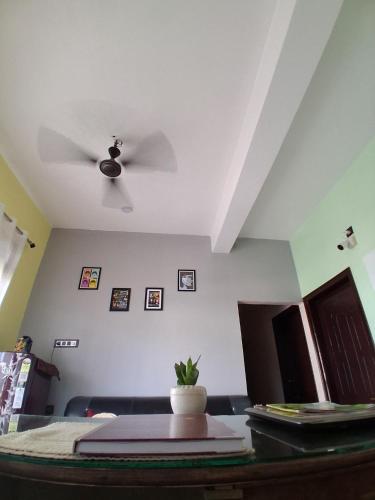 a living room with a ceiling fan and a table at Regal homes in Tezpur