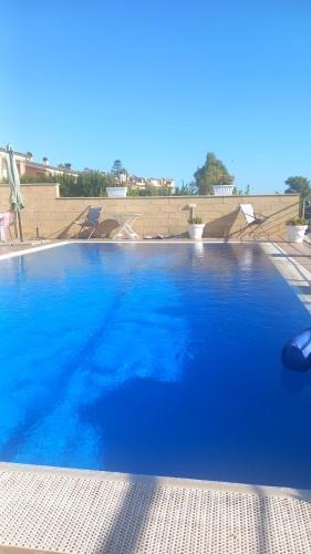 a large swimming pool with blue water at TUSCIA RELAx MARE in Civitavecchia