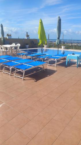 a group of blue tables and chairs on a roof at TUSCIA RELAx MARE in Civitavecchia