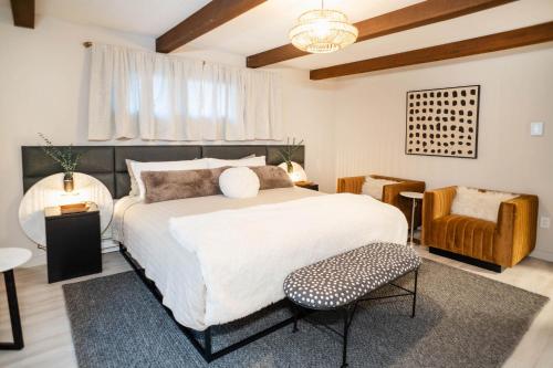 a bedroom with a large bed and a chair at Catskill MNTN Escape 5 BR 3 bath Villa Hot Tub Fire Pit Best Group Stay in Prattsville