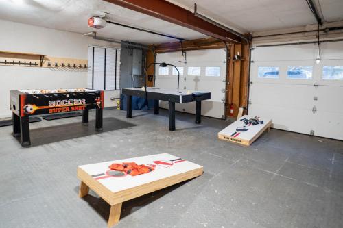 a garage with a ping pong table at Catskill MNTN Escape 5 BR 3 bath Villa Hot Tub Fire Pit Best Group Stay in Prattsville