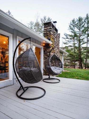 two baskets sitting on top of a porch at Catskill MNTN Escape 5 BR 3 bath Villa Hot Tub Fire Pit Best Group Stay in Prattsville
