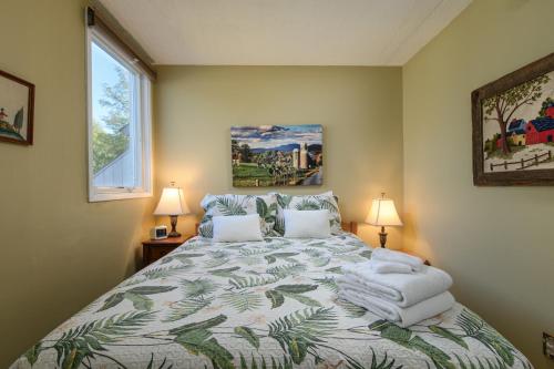 a bedroom with a large bed with towels on it at Bridges 19 condo in Sugarbush Village