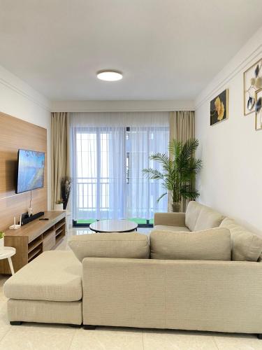 a living room with a couch and a table at Dee Homes in Ruaka
