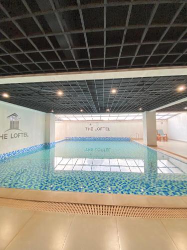 a large swimming pool in a building at Dee Homes in Ruaka