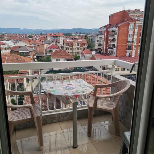 a table and chairs on a balcony with a view at Zenith Center Apartment in Ohrid