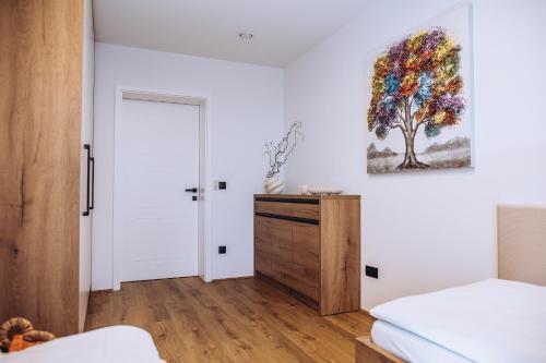 a bedroom with a bed and a painting on the wall at Apartmány Orlí in Hranice