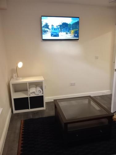 a flat screen tv hanging on a white wall at Lower Cheltenham Place in Bristol