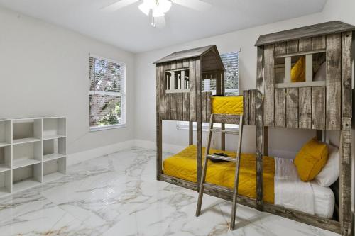 a bedroom with two bunk beds in a room at The Golden Gem in Valrico