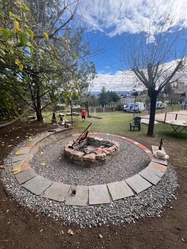 a fire pit in a park with people sitting around it at Montecielo in San Antonio de Arredondo