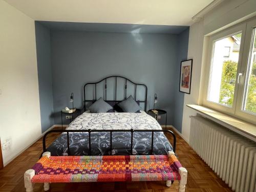 a bedroom with a bed with a quilt on it at Das Grüne Nest in Neckarsteinach