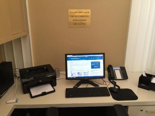 a desk with a computer and a printer and a phone at Chancellor Hotel on Union Square in San Francisco