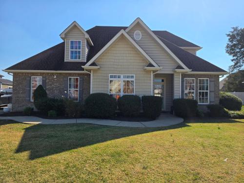a house with a large lawn in front of it at Boro Breeze Vacation Rental in Murfreesboro