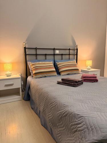 a bedroom with a large bed with two night stands at WINDSOR PLACE APARTMENT - SELF CHECKIN with CODE in Athens