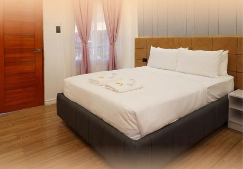 a bedroom with a large bed with white sheets at Summit Resort and Sports Hub 