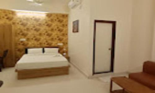 a bedroom with a bed and a door in it at Grand Vista Inn in Bengaluru