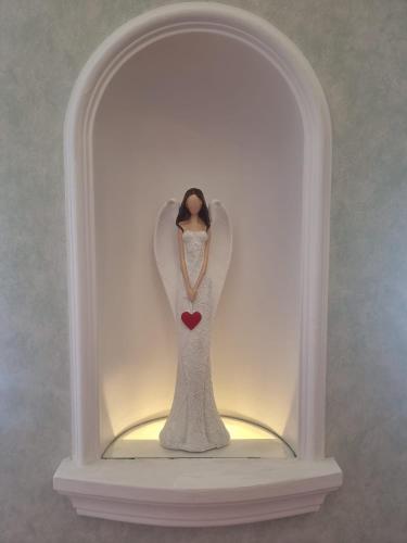a figurine of a woman in a dress in a glass case at ABC Homestay in Golčŭv Jeníkov