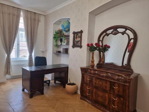 an office with a desk and a dresser with a mirror at ABC Homestay in Golčŭv Jeníkov