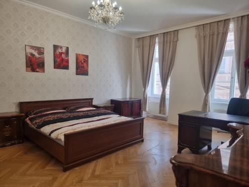 a bedroom with a bed and a desk and a piano at ABC Homestay in Golčŭv Jeníkov