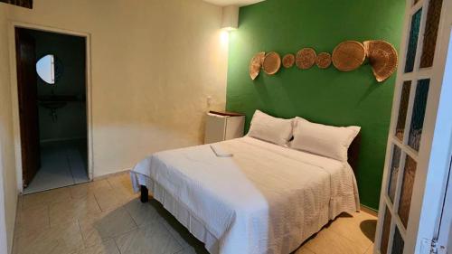 Una cama o camas en una habitación de Pousada Numar Maresias